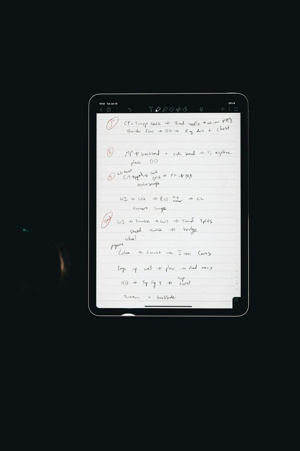 Digital tablet showing handwritten yoga exercise notes.